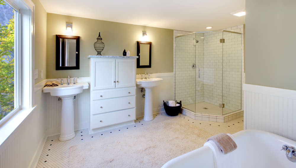 Luxury bathroom with tub and modern shower and double sink