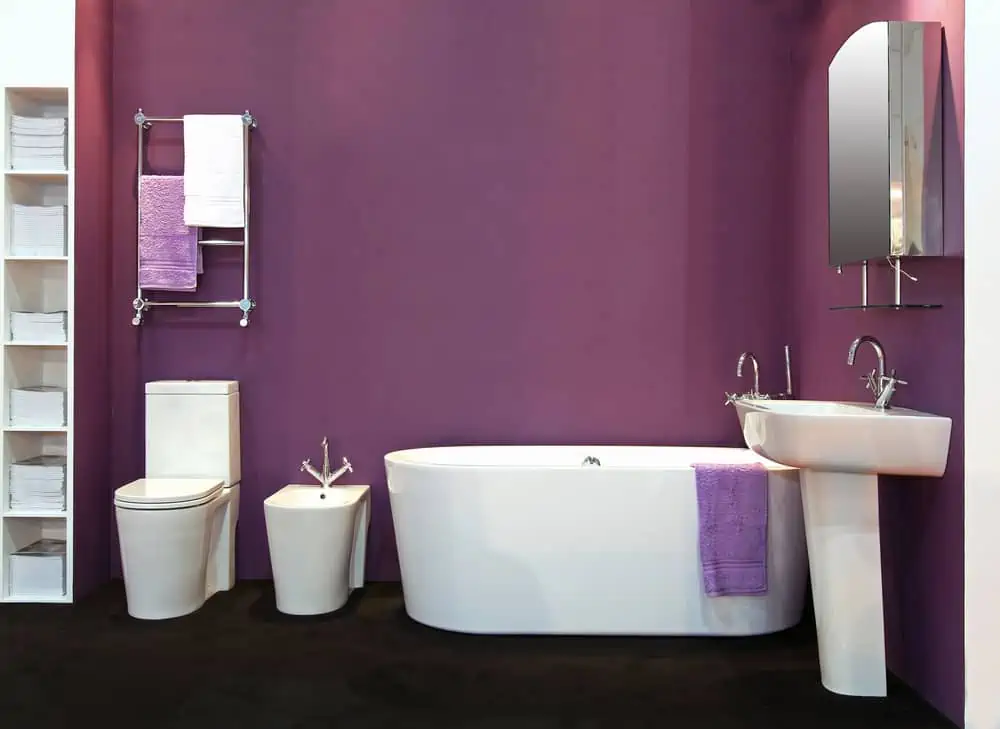 Modern design bathroom with purple wall and accessories