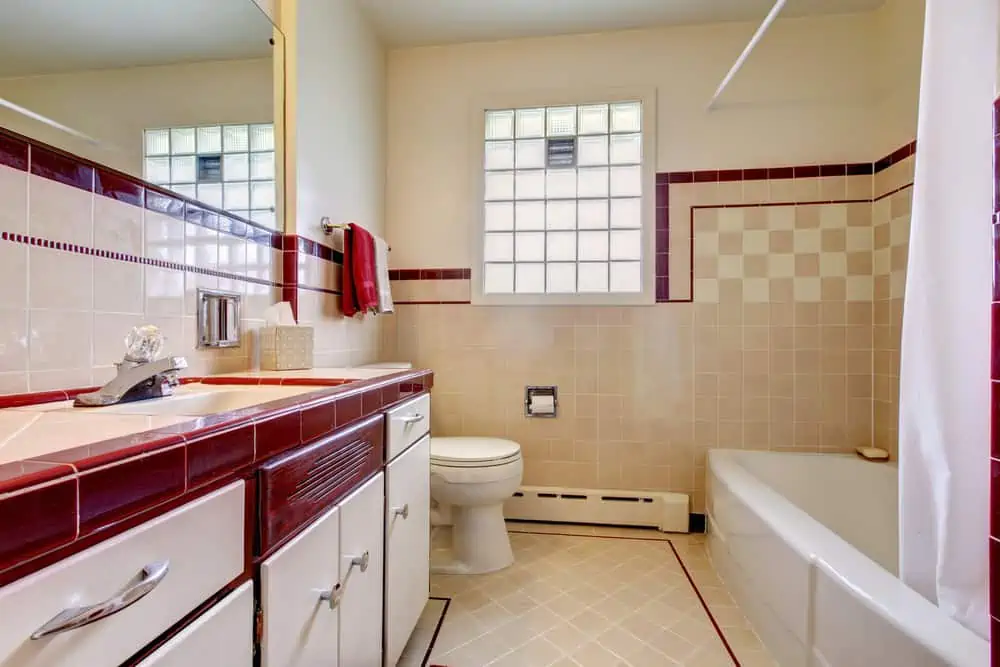 Bathroom with tile wall trim and glass block window
