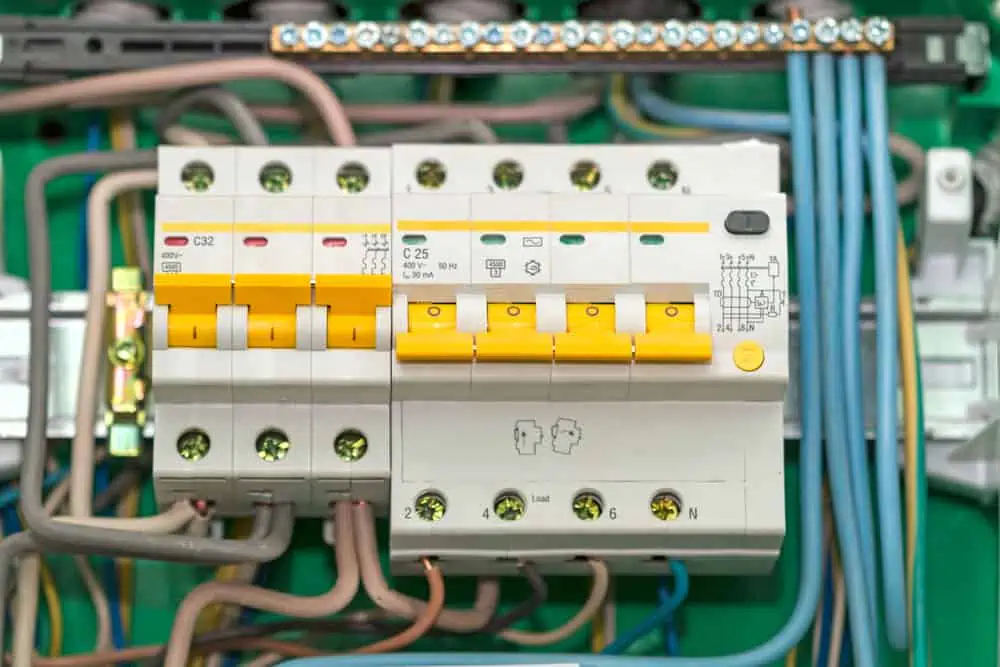 Electric board with circuit breakers. Circuit breaker used on items such as a residential iron, hot water heater, a kitchen oven, or an electric clothes dryer.