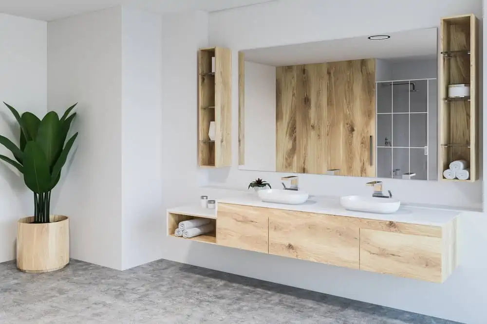 White bathroom corner, double sink and plant