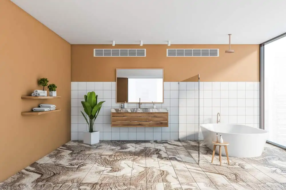 Interior of luxury bathroom with white and orange walls, marble floor, comfortable bathtub and double sink with mirror. 3d rendering
