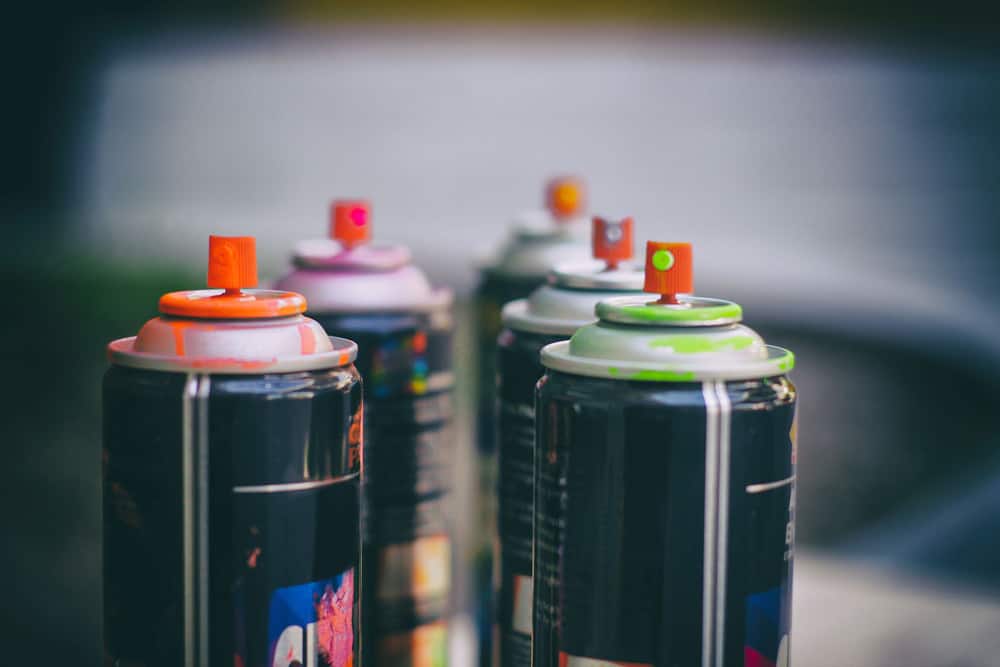 Photograph of some spray paint cans and a blurred background
