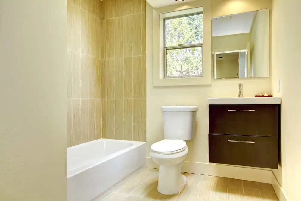 New modern yellow bathroom with beige tiles.