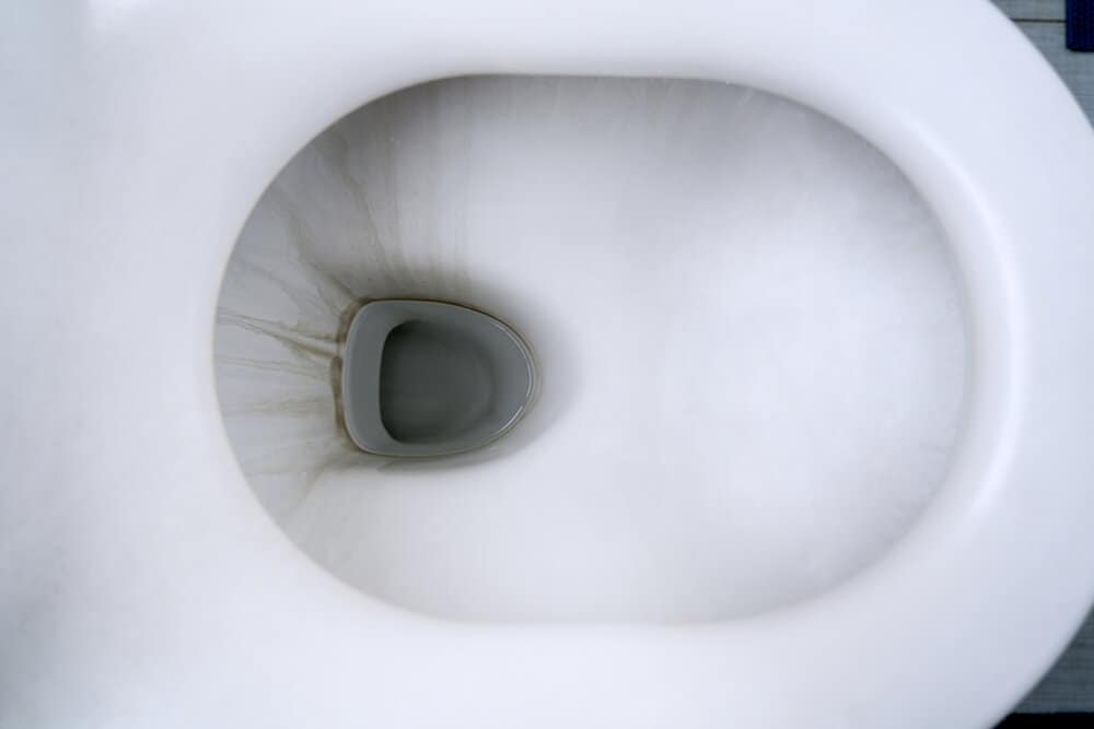 Top view of dirty toilet bowl with limescale stain in the bathroom