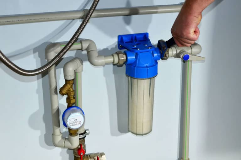 Mounting of house rainwater filter system. Borehole drilling and