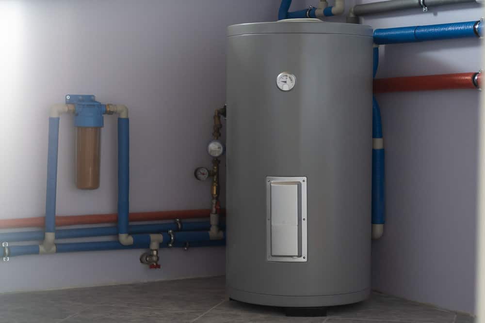 Tank for indirect heating of boiler, flow filter for cleaning, boiler piping and meters in boiler room of private house