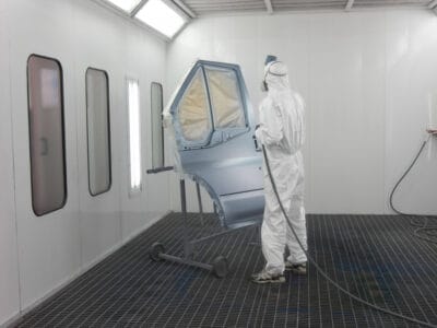 Painter works in a spray booth