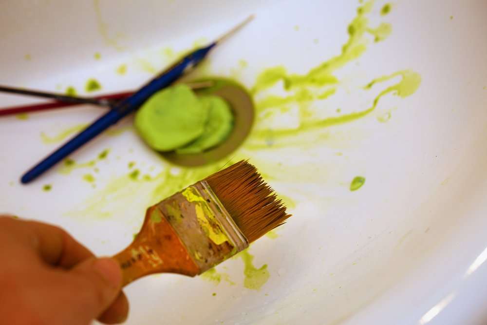 Cleaning paint brushes in the sink
