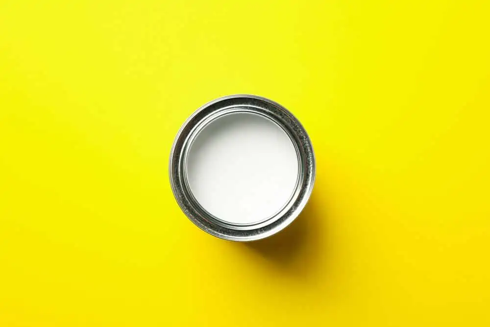 Paint can on yellow background