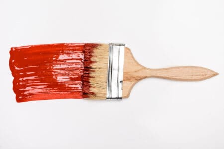 Paint brush with red pain on white background
