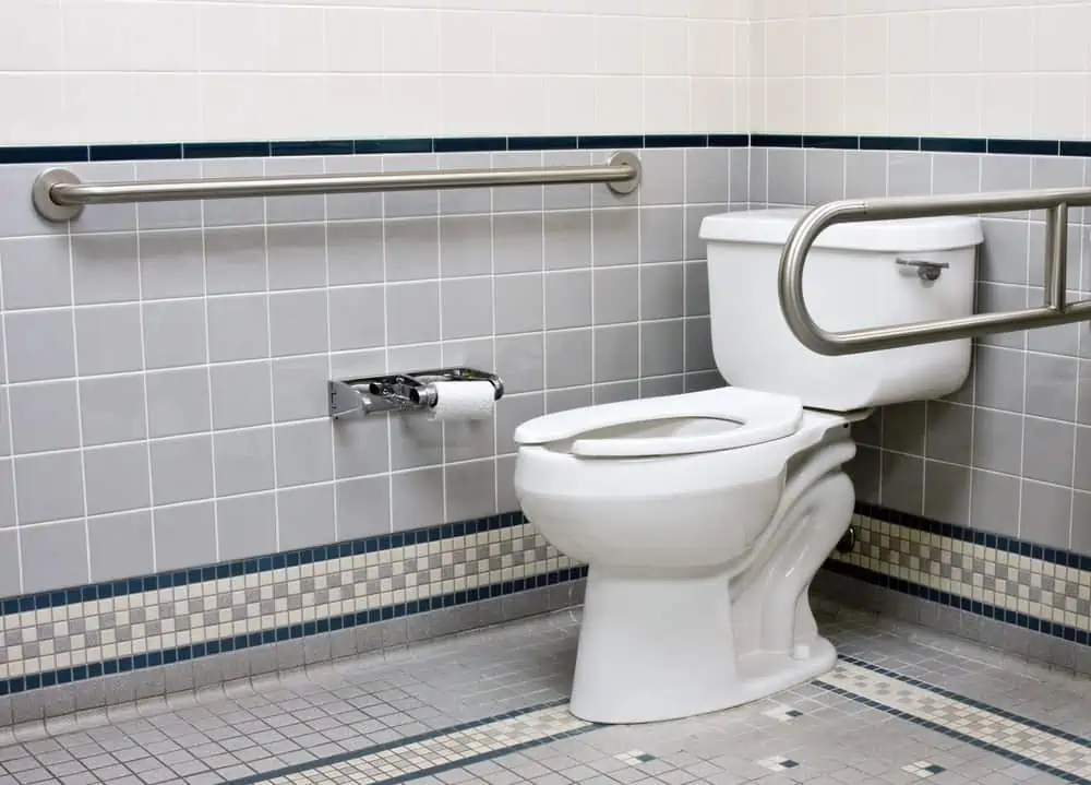 Handicap bathroom with stainless steel support bars and ceramic tile