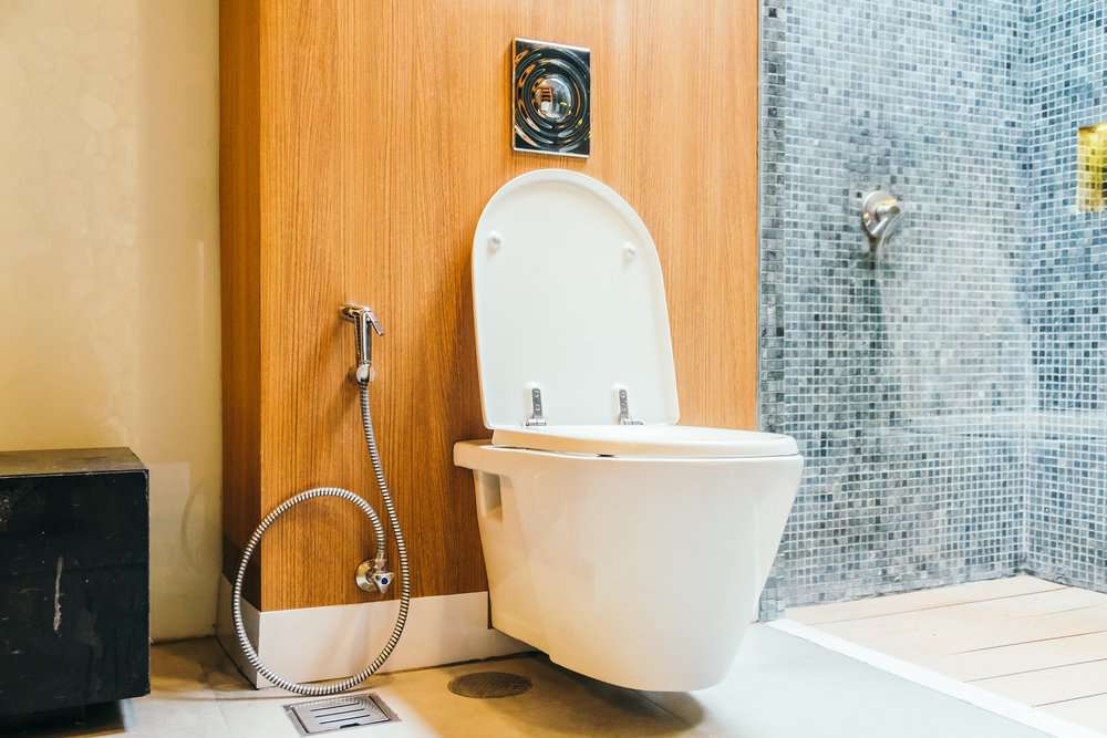 White wall-hung toilet bowl in modern bathroom interior