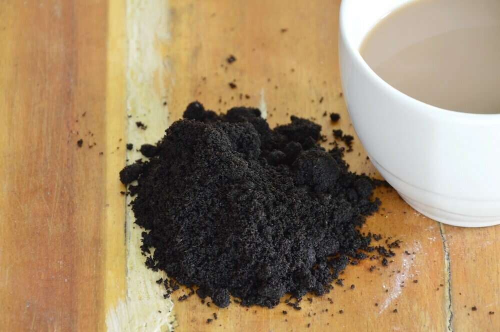 Coffee grounds on the table with glass cup