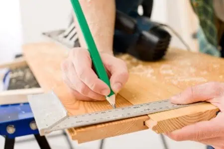 Handyman prepare wooden floor in workshop