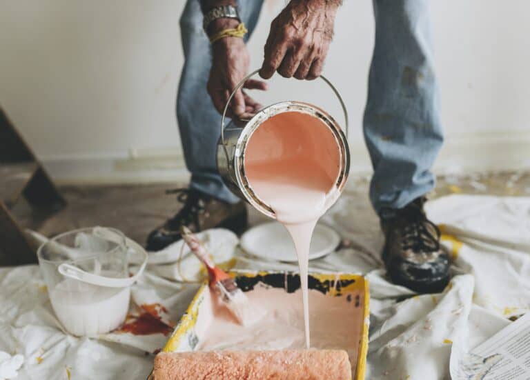 Man pouring paint into tray